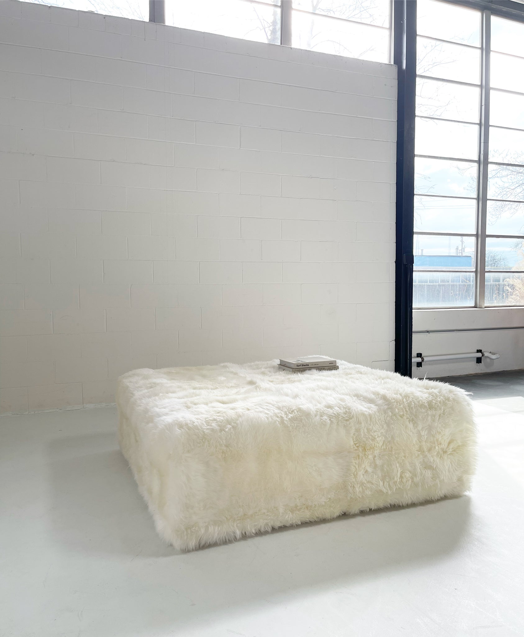 The Forsyth Large Ottoman in Sheepskin, 56 x 56 in