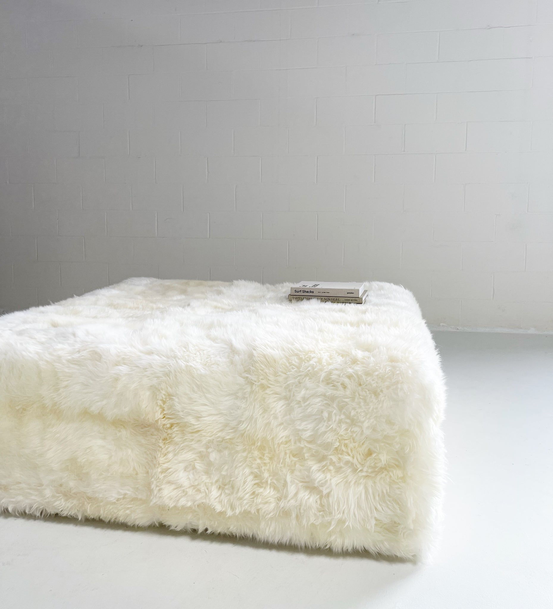 The Forsyth Large Ottoman in Sheepskin, 56 x 56 in